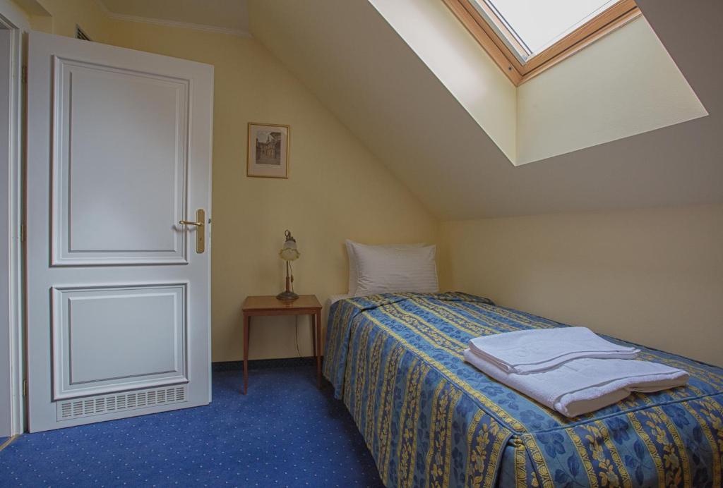 Postel nebo postele na pokoji v ubytování Hotel Tyl