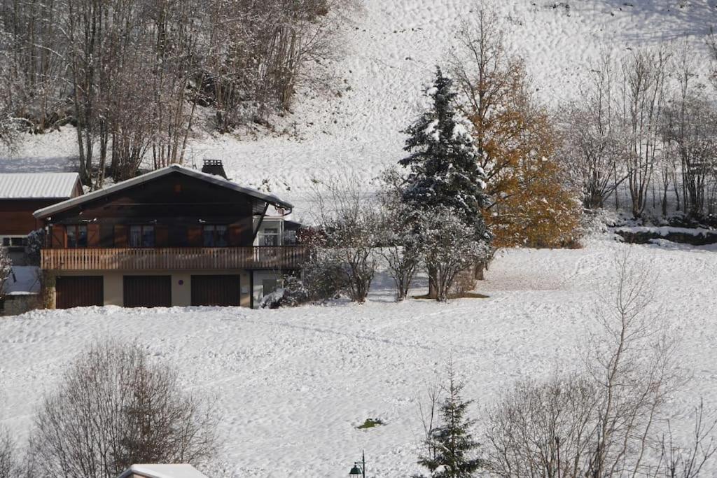 a house on a snow covered hill with a house at Chalet de montagne Pierre et Gaby non-fumeur hôte non professionnel in Saint-Jean-dʼAulps