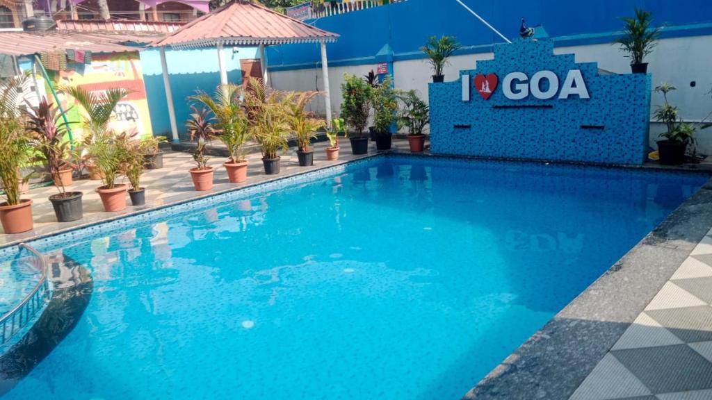 a swimming pool at a resort with a blue pool at Blue rays in Calangute