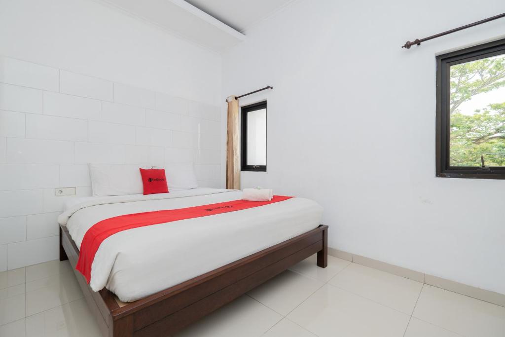 RedDoorz near Jawa Timur Park 3 tesisinde bir odada yatak veya yataklar