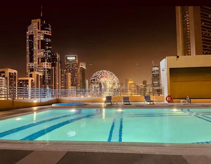 a large swimming pool on the roof of a building at Amazing 3BR Apartment next to Emirates Towers Metro in DIFC in Dubai