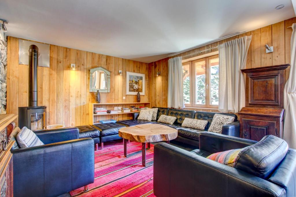 a living room with couches and a table at Auberge RDC in Morzine