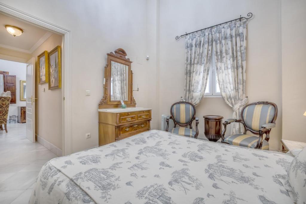 A bed or beds in a room at Palacio Marqués Vega Armijo & Parking incluido