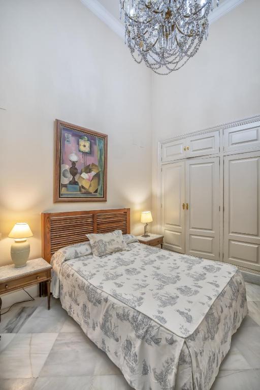 A bed or beds in a room at Palacio Marqués Vega Armijo & Parking incluido