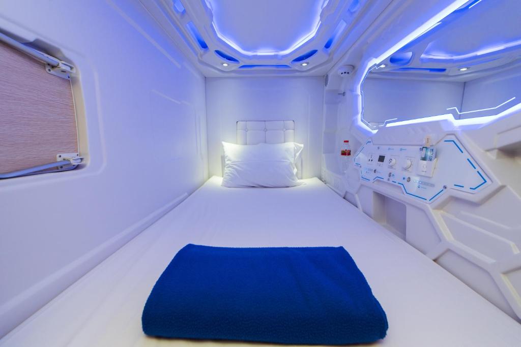 a room with a bed in a hospital room at Passgo Digital Airport Terminal 3 Soekarno Hatta in Tangerang