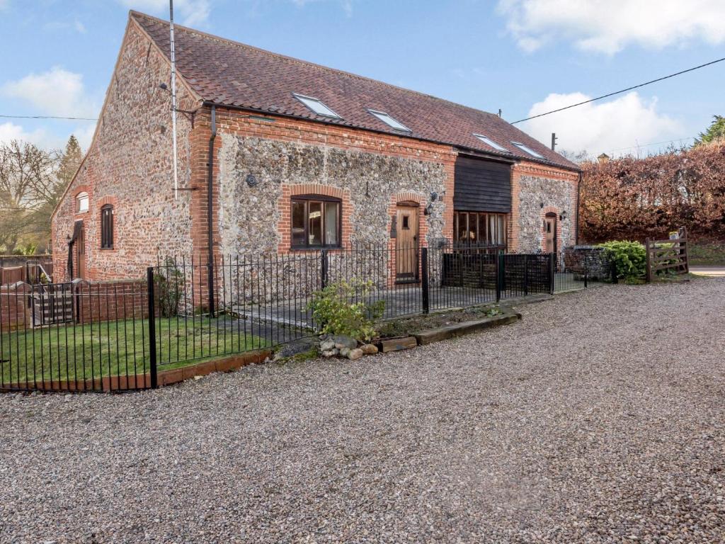 an old brick building with a fence in front of it at 3 Bed in Corpusty OTTN8 in Corpusty