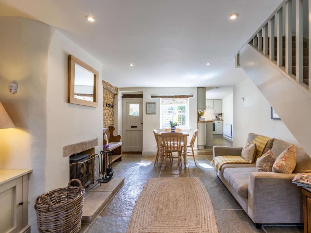 a living room with a couch and a fireplace at 2 Bed in Bourton-on-the-Water 28292 in Bourton on the Water