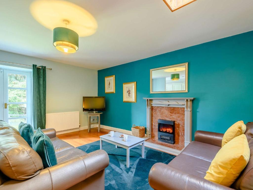 a living room with a couch and a fireplace at 2 Bed in Sanquhar 89403 in Sanquhar