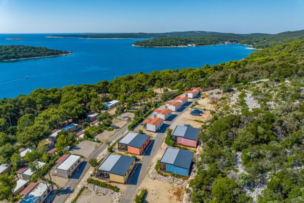 an aerial view of a group of houses next to a lake at Luxury Sea View Kasthouses - Happy Rentals in Mali Lošinj