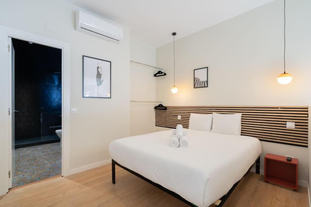 a white bedroom with a large white bed in it at Nice studio in Madrid-Fp02 in Madrid