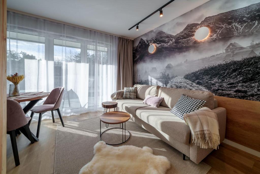 una sala de estar con un sofá y una mesa en RentPlanet - Apartamenty Zakopiańskie II, en Zakopane