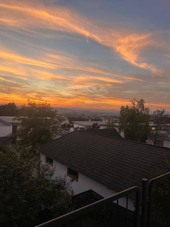 a view of a sunset from a roof of a house at Sunset Apartment mit Rheinblick in Urbar in Urbar-Mayen-Koblenz
