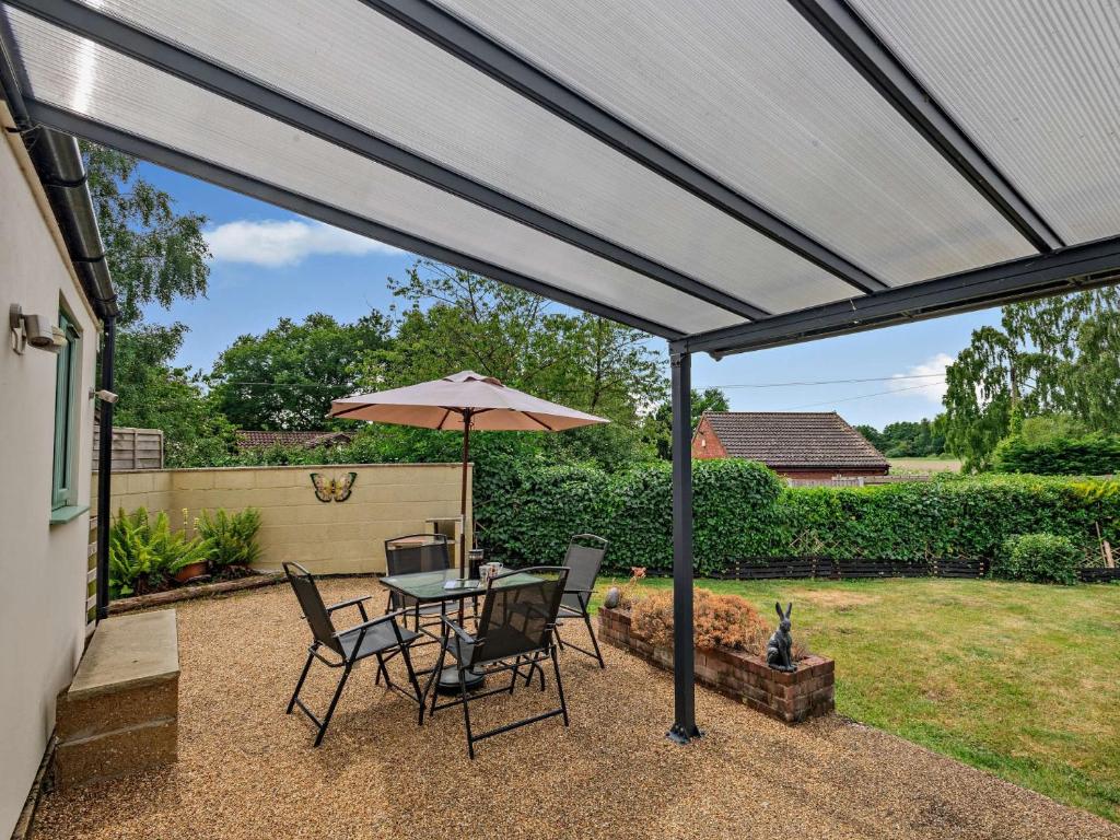 a patio with a table and an umbrella at 1 Bed in Brundall 46293 in Brundall