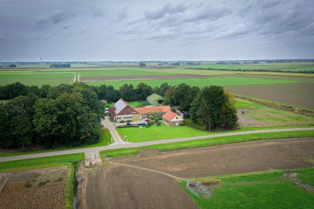 an aerial view of a house in a field at Boerderijcamping de Hinde in Dronten