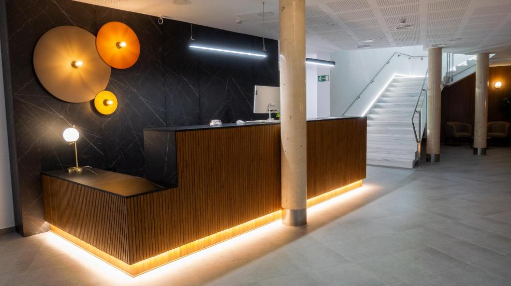 a lobby with a reception desk and a staircase at HOSPEDERIA BODEGA NUESTRA SEÑORA DEL ROSARIO in El Provencio