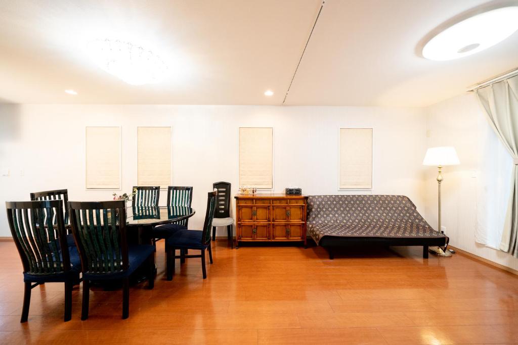 a bedroom with a bed and a table and chairs at Shinokubo guest house in Tokyo