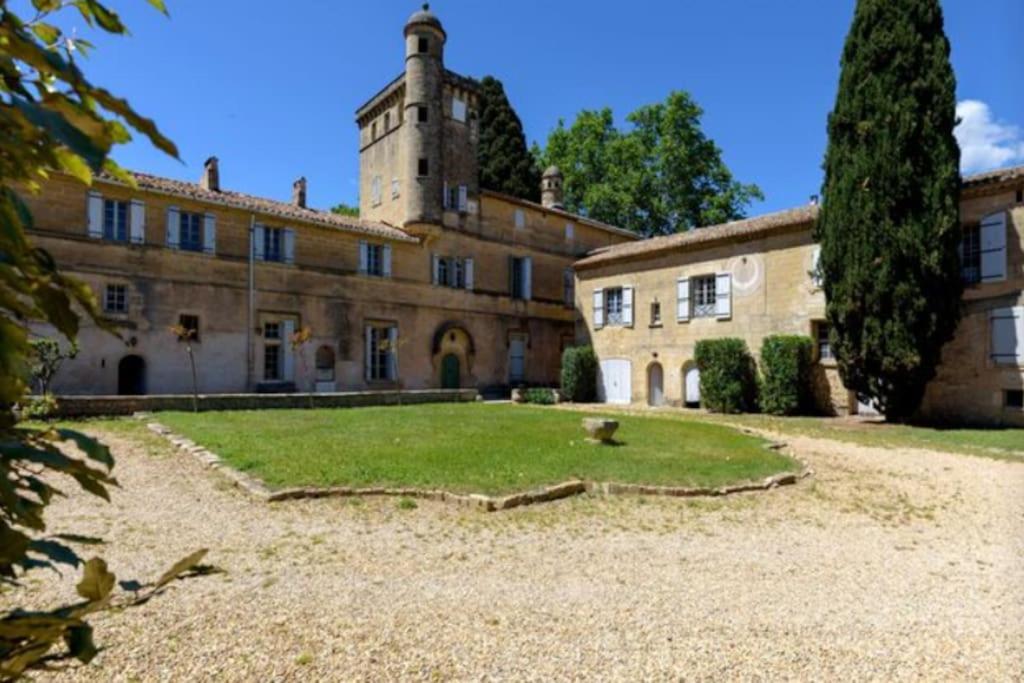 an old building with a tower on top of it at Château Teillan-Porte Italienne in Aimargues