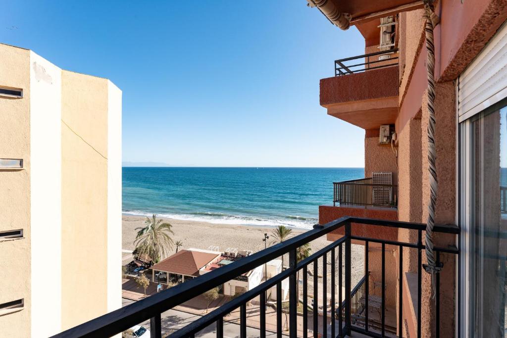 a balcony with a view of the beach at La Perla in Fuengirola