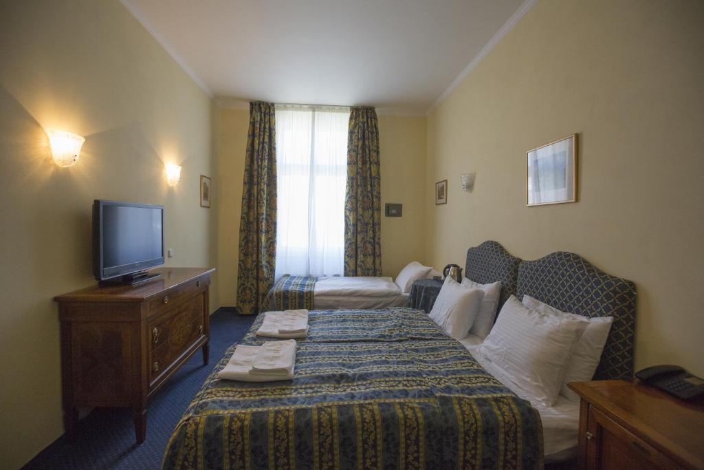 Postel nebo postele na pokoji v ubytování Hotel Tyl