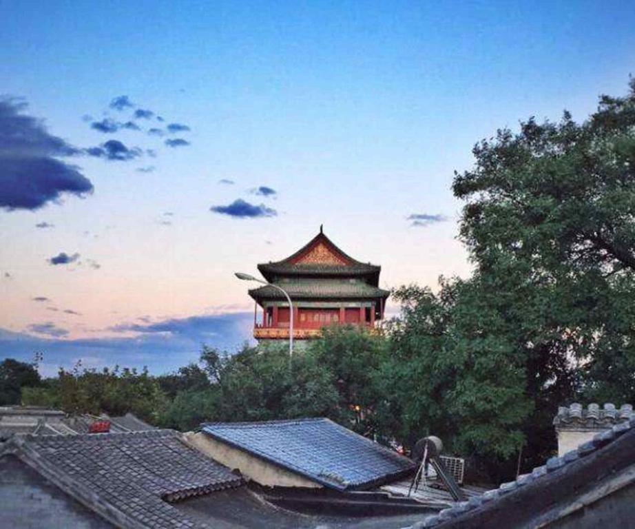 a building in the distance with a sky at The East Hotel-Very close to the Drum Tower,The Lama Temple,Houhai Bar Street,and the Forbidden City,There are many old Beijing hutongs around the hotel Experience the culture of old Beijing hutongs,Near Exit A of Shichahai on Metro Line 8 in Beijing