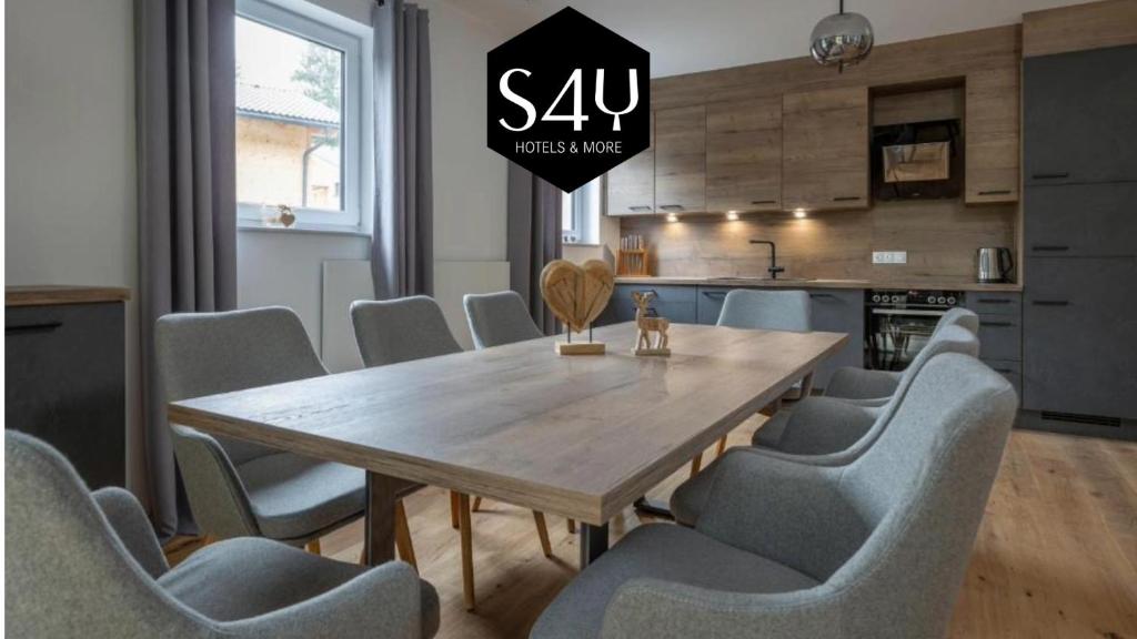 una sala da pranzo con tavolo e sedie in legno di My Turrach Grünsee Chalet by S4Y a Turracher Hohe