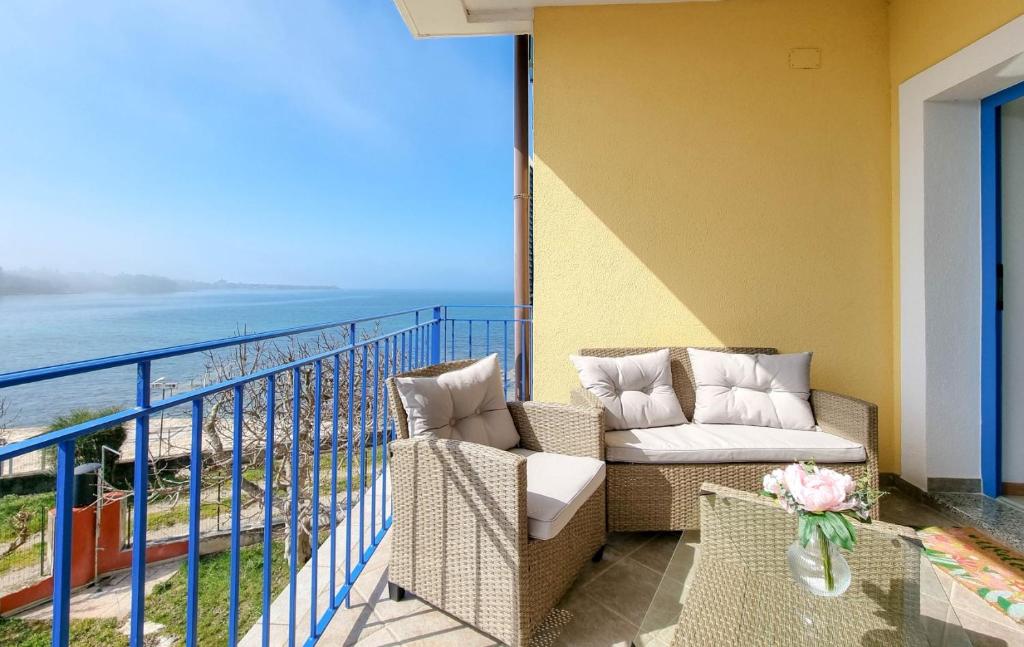 a balcony with a couch and chairs and the ocean at Belvedere dole in Novigrad Istria