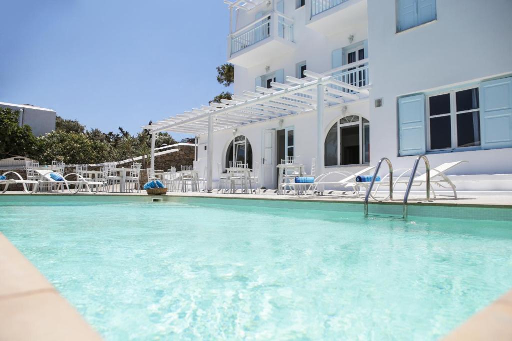 a swimming pool in front of a white building at Anamar Blu in Ornos