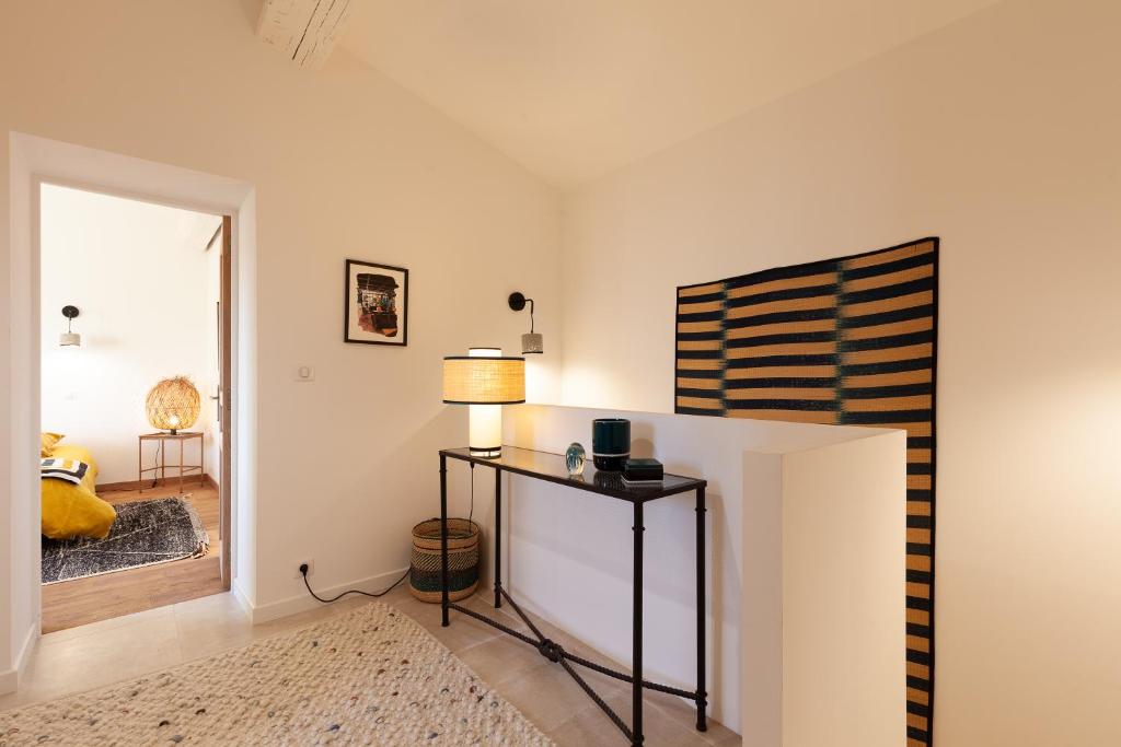 a room with a table with a lamp and a window at La Petite Bastide in Sanary-sur-Mer