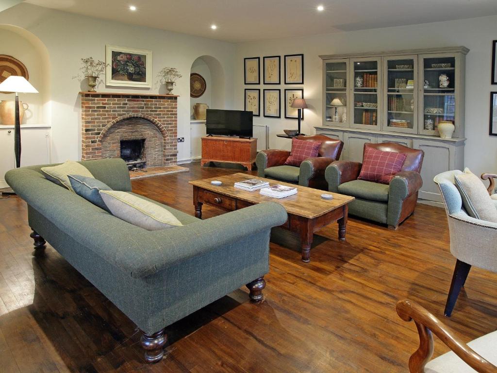 a living room with couches and a fireplace at 3 Bed in Eastbourne 57383 in Alfriston