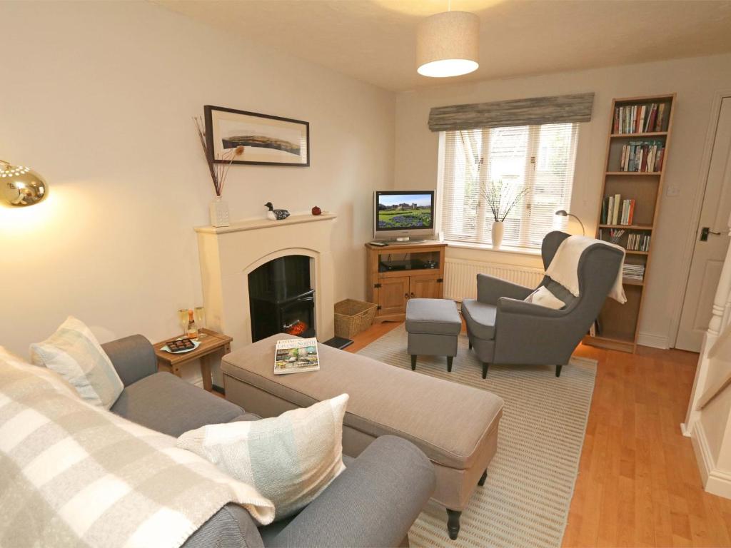 a living room with a couch and chairs and a fireplace at 2 Bed in Alnwick CN101 in Alnwick