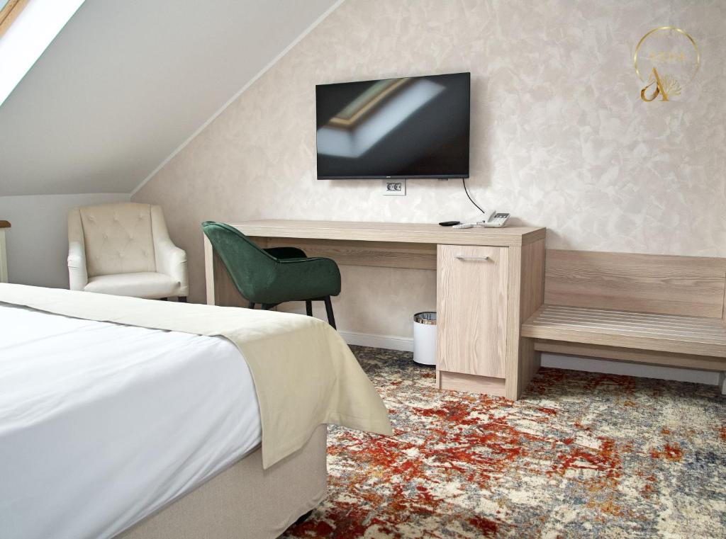 TV a/nebo společenská místnost v ubytování Hotel Anda