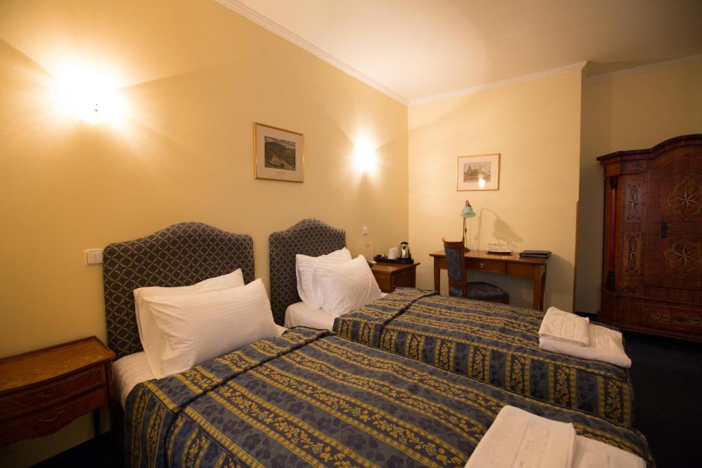 Postel nebo postele na pokoji v ubytování Hotel Tyl