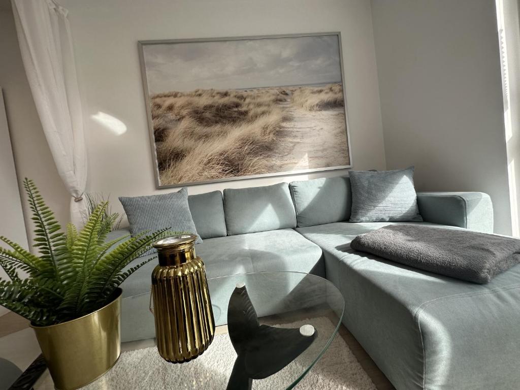 a living room with a couch and a glass table at Ferienwohnung SEESTERN **** in Rostock