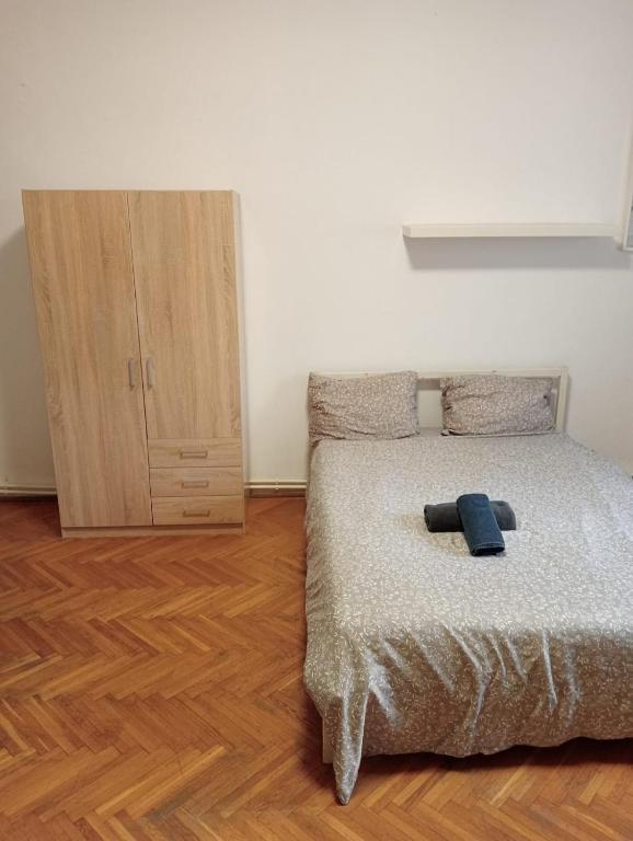 a bedroom with a bed and a wooden floor at Romana City Center Studio in Bucharest