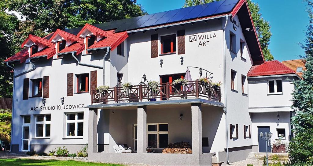an older white building with red roof at Willa Art in Szklarska Poręba