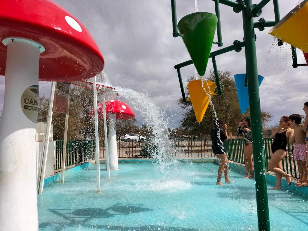 a group of people playing in a water park at Cabañas Ecodesert in La Tirana