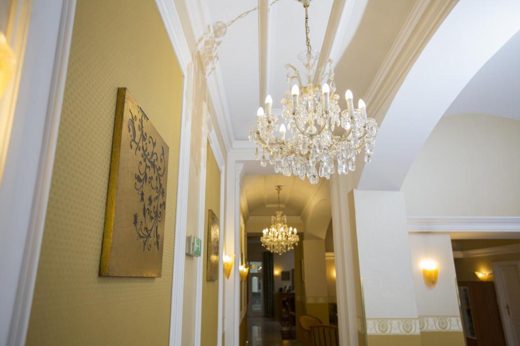 a chandelier hanging from the ceiling in a hallway at Hotel Tyl in Prague