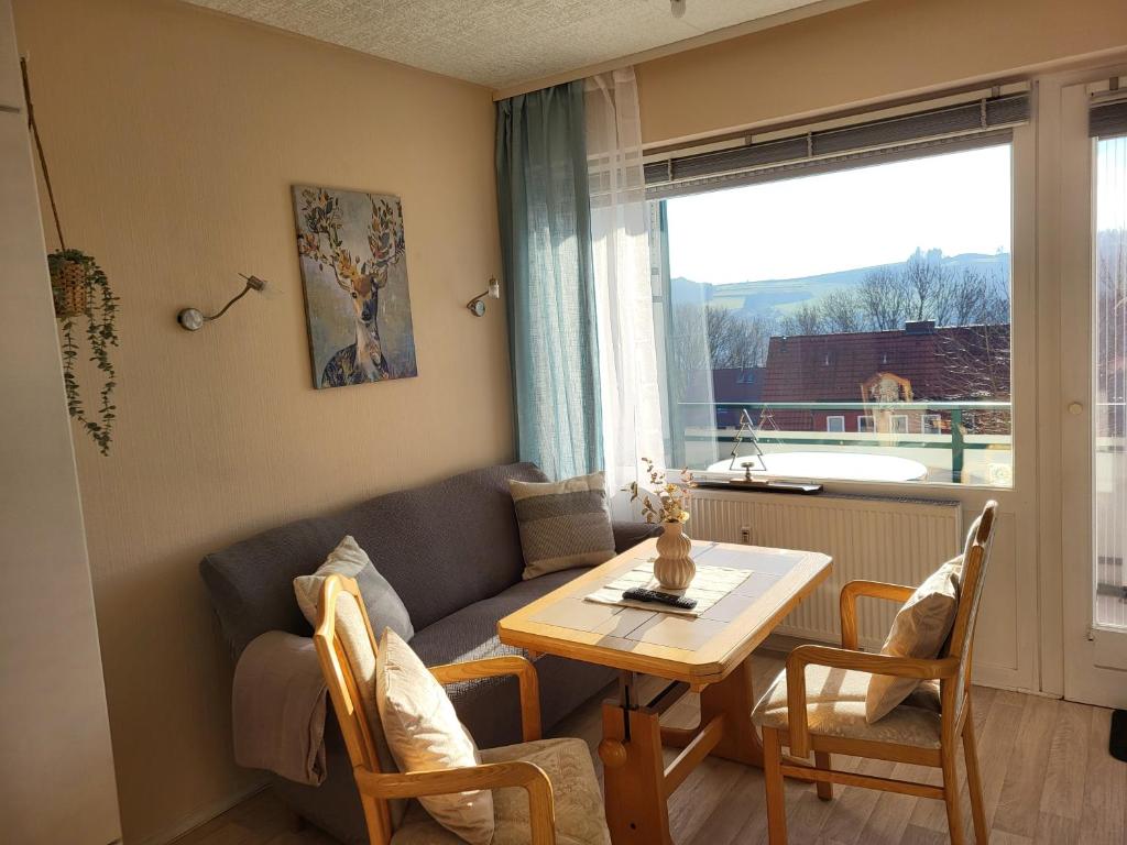 a living room with a couch and a table at FeWo Talblick 22 in Bad Lauterberg