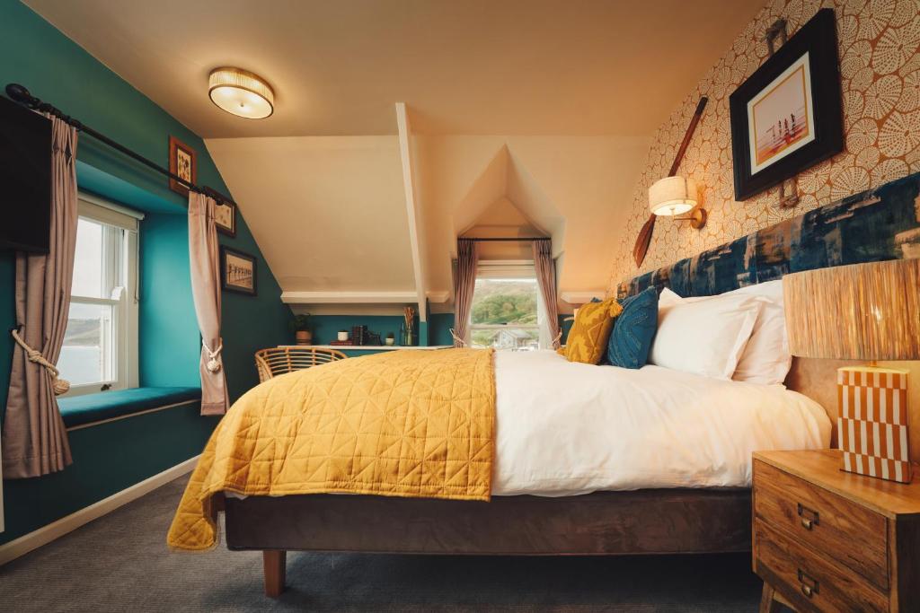 a bedroom with a large bed and a window at The Old Success Inn in Sennen Cove