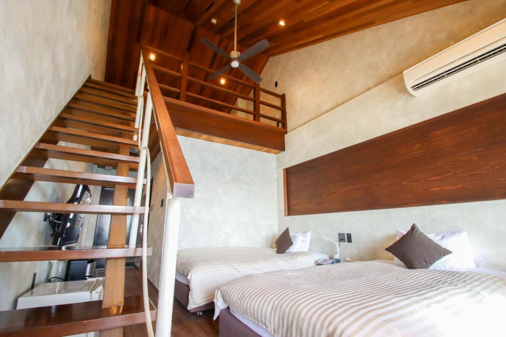 Postel nebo postele na pokoji v ubytování Petit Resort Native Sea Amami