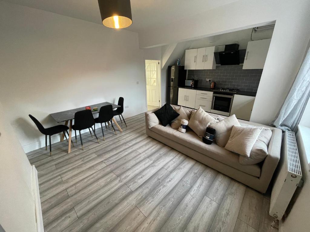 a living room with a couch and a table at Spacious 4-Bedroom House in Manchester in Manchester