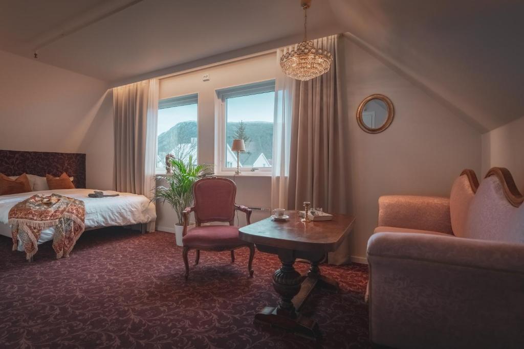 a hotel room with a bed and a couch at Villa Havblikk Tromsø in Tromsø