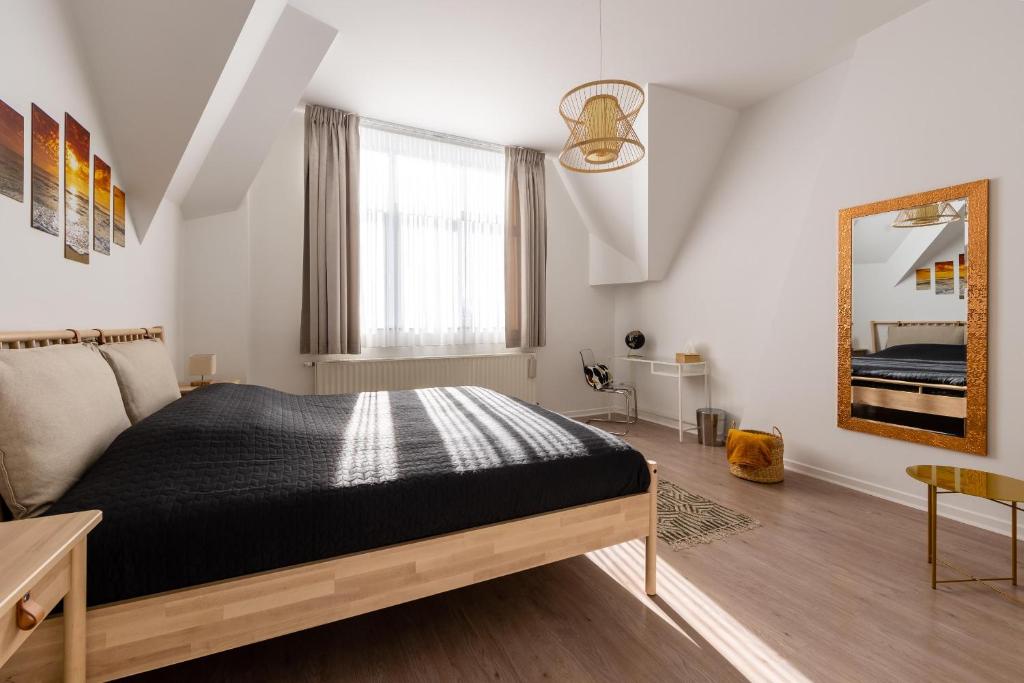 a bedroom with a bed and a mirror at House of Lara in Brussels