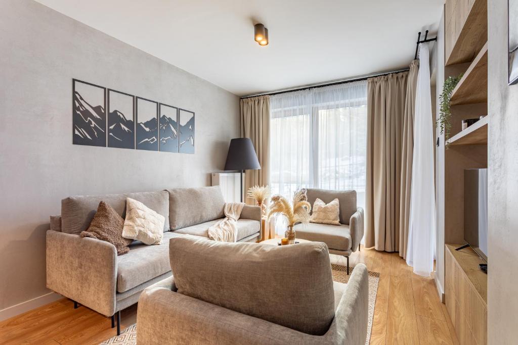 a living room with a couch and two chairs at Mountain Tree Apartament C27 Apart Invest in Szklarska Poręba