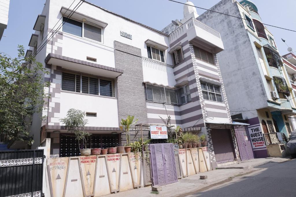 a white building with a fence in front of it at 3 BHK-Air Coolers for 4 to 10 Guests for Families in Hyderabad