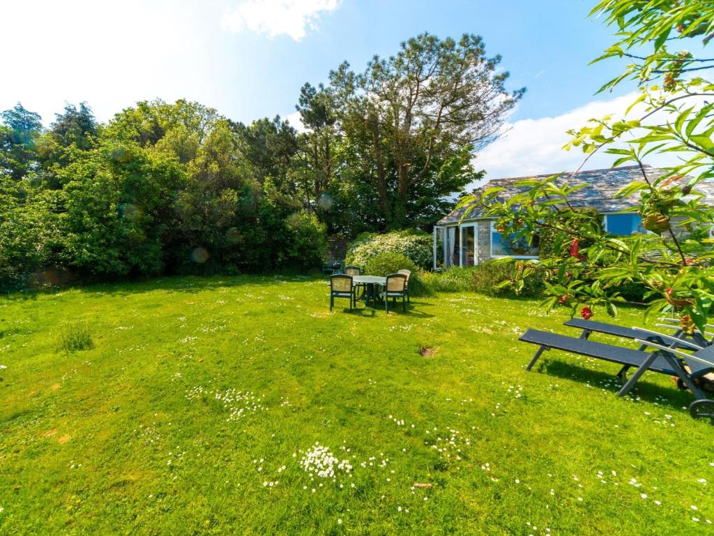 a yard with two benches in the grass at 1 Bed in Isle of Purbeck IC131 in Worth Matravers