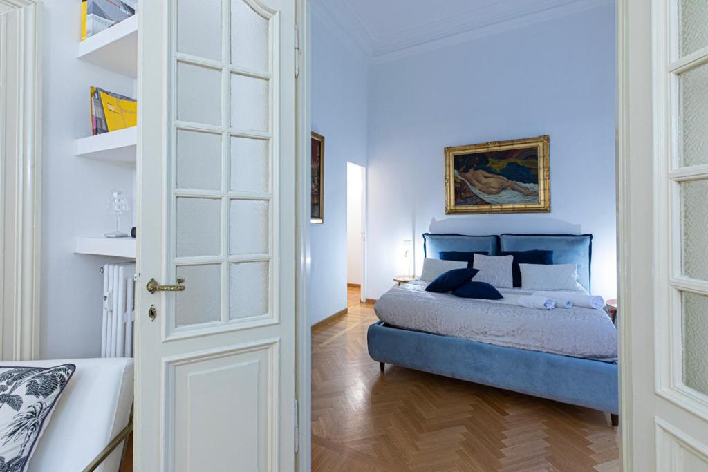 a bedroom with a blue bed in a room at Antonelli Place in Rome