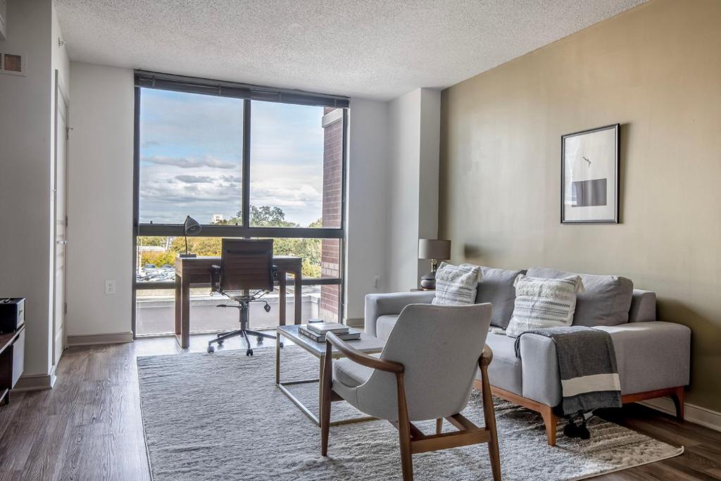 a living room with a couch and a table at Bethesda 1br w doorman pool gym nr metro WDC-722 in Bethesda