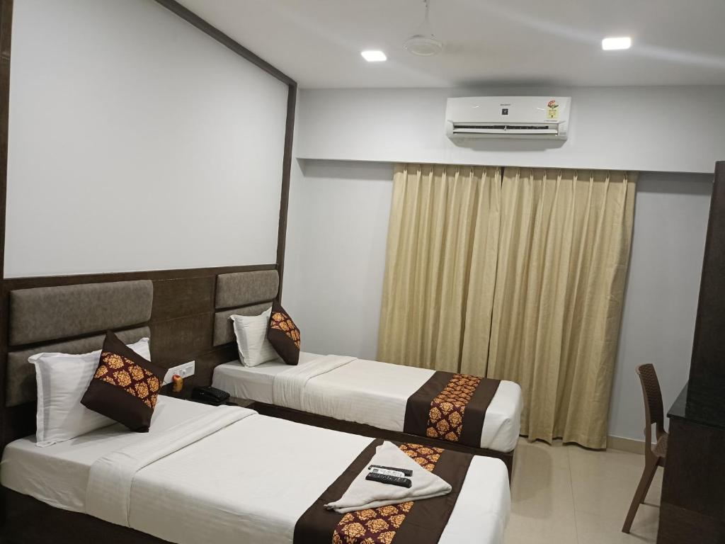 Postel nebo postele na pokoji v ubytování Hotel Zain Grande
