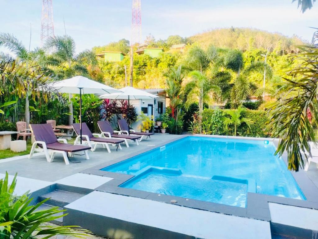 a swimming pool with chairs and a resort at Andawa Lanta Resort in Ko Lanta